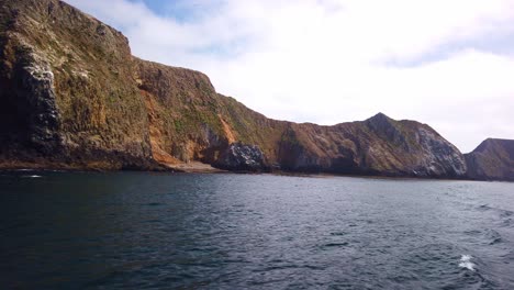 Gimbal-close-up-shot-from-a-moving-boat-of-the-rugged-coastline-of-East-Anacapa-Island-at-Channel-Islands-National-Park-in-the-Pacific-Ocean