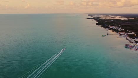 Aerial-over-the-beach-and-resort-near-the-'Secret-Beach-Belize'-on-Ambergris-Caye-or-Bay,-Belize