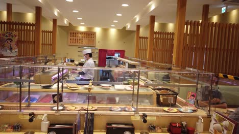 sushi-Japanese-traditional-food-in-restaurant-with-dishes-in-conveyor-belt