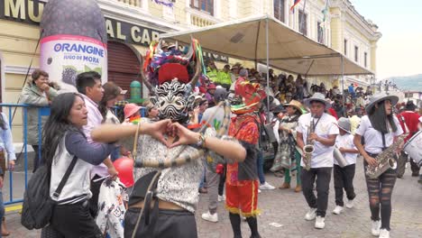 Be-captivated-by-the-expressive-dance-of-a-Diablada-Pillareña-performer-as-he-energetically-sends-kisses-and-forms-a-heart-gesture,-all-captured-in-stunning-4K-resolution-and-60-frames-per-second