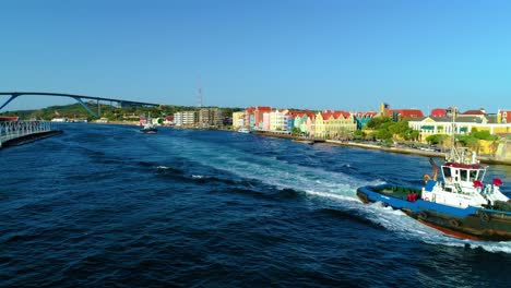 Tug-boats-cross-piloting-river-through-Willemstad-curacao-river-entrance