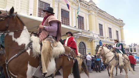 Experience-the-authentic-charm-of-Chagras-as-they-elegantly-ride-on-horseback,-adorned-with-ponchos,-zamarros,-and-hats,-all-captured-in-stunning-4K-resolution-and-60-frames-per-second