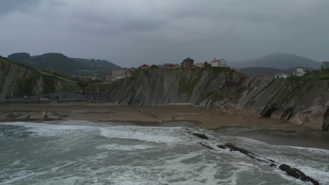 Aerial-pan-acros-itzurun-beach-on-stormy-cloudy-day