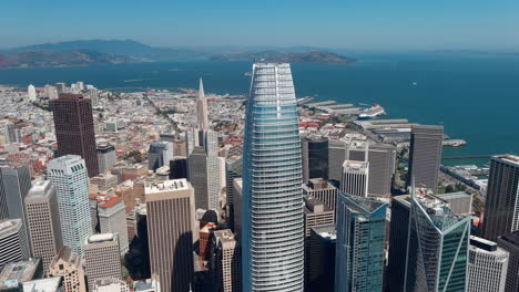 Salesforce-headquarters-in-San-Francisco-towers-above-and-dominates-SF-skyline,-aerial