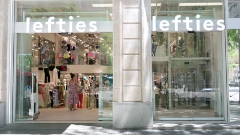 A-shopper-enters-the-Spanish-fashion-brand-owned-by-Inditex,-Lefties,-store-in-Spain