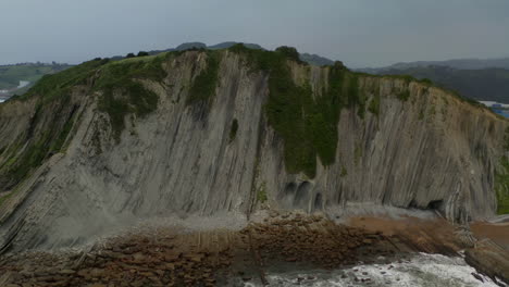 Aerial-trucking-pan-around-geologic-flysch-fissures-in-sea-cliffs-of-zumaia-spain