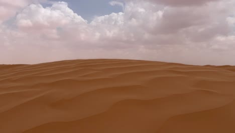 Sand-blowing-over-Sahara-desert-dune-on-windy-and-cloudy-day