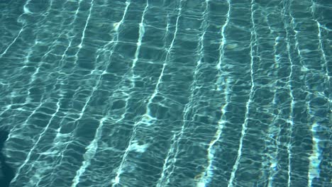 Water-surface-texture,-Slow-motion-looping-clean-swimming-pool-ripples-and-wave,-Refraction-of-sunlight-top-view-texture-sea-side-white-sand,-sun-shine-water-loop-background,
