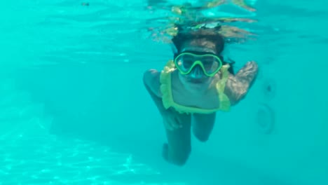 Little-girl-swims-underwater-in-an-underwater-panoramic-mask.-A-child-snorkels.-Bubbles-surround-the-baby-on-all-sides.