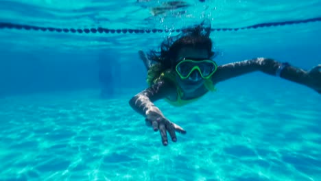 Little-caucasian-girl-with-mask-and-snorkel-swimming,-gopro-underwater-footage