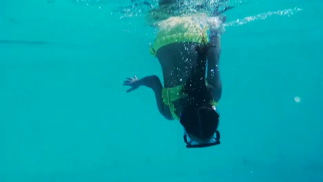 Little-girl-with-mask-swimming,-gopro-underwater-footage