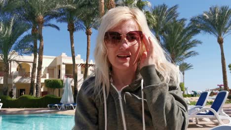 head-shot-woman-video-chat-near-palm-trees