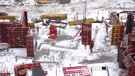 construction-of-modern-high-rise-buildings-in-wintertime.-aerial-view-from-flying-drone