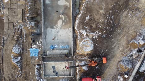 Drones-aerial-of-a-construction-site-of-a-pool,-formwork-concrete-blocks-already-finished-and-bricked-up-with-construction-adhesive,-steps-already-prepared-and-ready-for-concrete-filling.