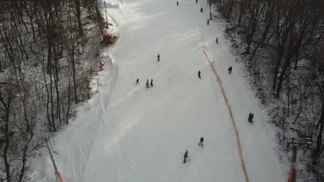 Drone-view-at-slope-on-ski-resort.-Forest-and-ski-slope-from-air.-Winter-landscape-from-a-drone.-Snowy-landscape-on-ski-resort.-Aerial-photography