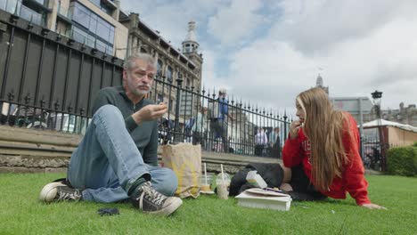 Father-and-Daughter-enjoy-lunch-in-Princess-Street-Gardens,-Edinburgh