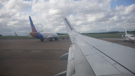 Ryanair-Airplane-airliner-taxiing-on-the-runway-at-an-airport-window-view-over-the-wing-from-the-cabin