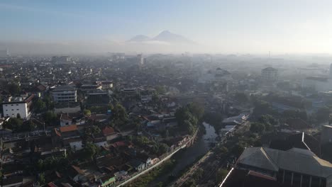 Aerial-view-of-downtown-Yogyakarta,-river,-buildings,-houses-and-small-streets-shot-in-the-morning