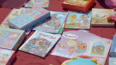 Children-books-and-games-displayed-on-the-floor-at-a-flea-market