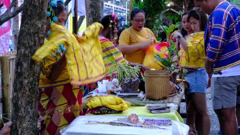 Group-of-women-in-Yellow-costumes-with-headdresses-preparing-their-stuff-to-sell