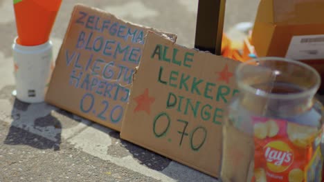 Homemade-and-handwritten-cardboard-sign-in-Dutch-to-sell-goods-at-flea-market