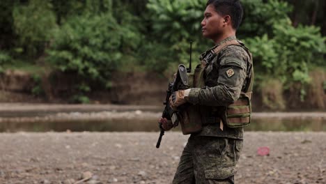 Ethnic-Male-Soldier-Caries-Gun-Through-The-Jungle