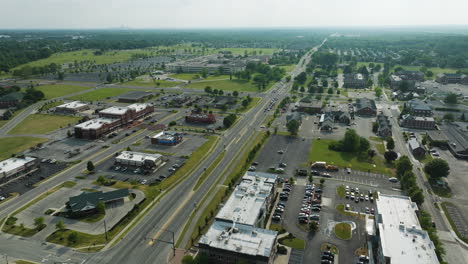 Aerial-of-road-and-parking-spaces-in-United-States-town-of-Lawrence,-sideways