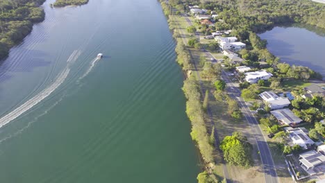 Aerial-View-Of-Jet-Ski-And-Boat-Cruising-In-Tweed-River-Along-The-Chinderah-In-NSW,-Australia