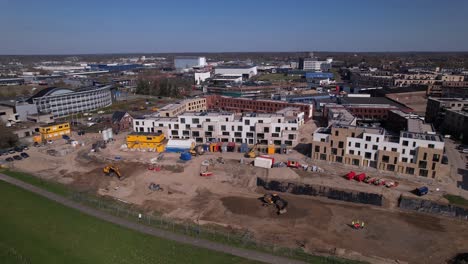 Meadow-floodplains-and-aerial-view-on-PUUR21-new-housing-construction-project-part-of-urban-development-in-Zutphen-with-plot-preparations-of-PRACHT-towers-Noorderhaven-neighbourhood-along-river-IJssel
