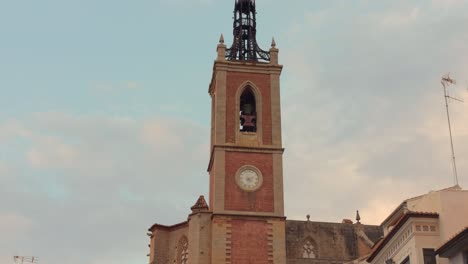 Tilt-shot-of-Parish-Church-Santa-Maria-bell-tower-detail-in-Sagunto-in-Spain