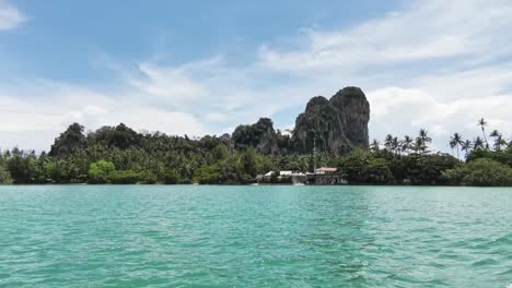 Amazing-Views-of-Railay-Rocks-near-Krabi-While-Departing-on-a-Longtail-Boat-with-Surrounding-Turquoise-Waters