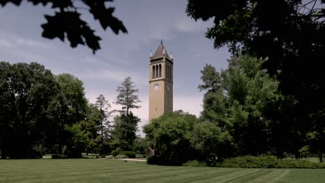 Stanton-Memorial-Carillon-Campanile-on-the-campus-of-Iowa-State-University-in-Ames,-Iowa-with-gimbal-video-stable-through-leaves