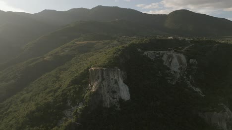 Misty-golden-sunlight-on-Hierve-el-Agua-rock-formation-in-MX-mountains