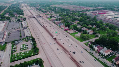 majestic-aerial-of-traffic-flow-above-Highway-I-90-and-CTA-Garfield-subway-Red-Line-from-south-side-chicago-looking-South-towards-West-Woodlawn