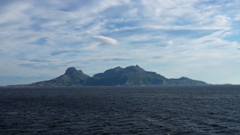 A-mountainous-island-is-seen-from-a-ferry-between-Bodø-and-Lofoten-in-Norway
