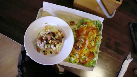 Chicken,-rice-and-salad-lunch-at-a-restaurant-in-Ames,-Iowa-with-video-moving-down-towards-food