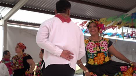 Slow-motion-shot-of-couples-dancing-traditional-dances-on-the-stage-at-the-guelaguetza