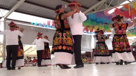 Slow-motion-shot-of-multiple-couples-dancing-together-at-the-Guelaguetza