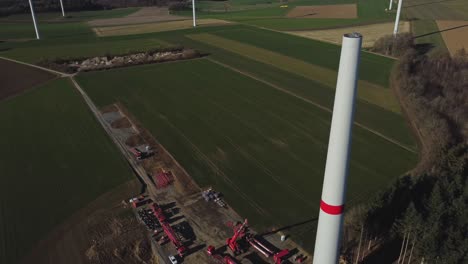 Aerial-View-Of-Wind-Turbine-Tower-During-Construction---drone-shot