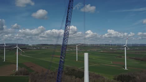Wind-Farm-Construction-Site-With-Huge-Crane---aerial-drone-shot-pullback