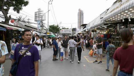 People-walk-the-vibrant-bustle-in-Bangkok's-Chatuchak-Market-with-locals-and-foreigners-shopping-in-Bangkok,-Thailand