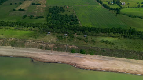 Cabins-alone-the-bluffs-at-Jurkalne-Seashore-beach-in-Latvia---aerial-view