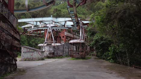 Backward-dolly-drone-flight-inside-the-ruins-of-the-old-cable-car-station-El-Liron,-located-in-San-Antonio-de-Galipan,-Venezuela