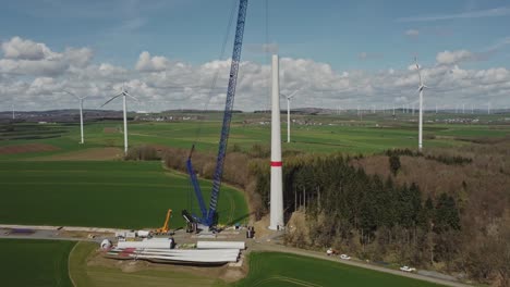 Wind-Turbine-Blades-And-Windmill-Parts-In-The-Construction-Site---aerial-drone-shot