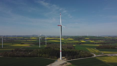 Aerial-View-Of-Wind-Turbine-Under-Construction-In-Scenic-Farm---drone-shot-arc