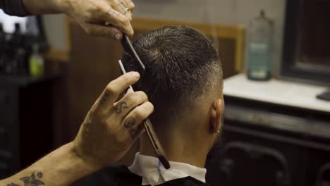 Barber-Cutting-Hair-With-Razor---close-up-shot