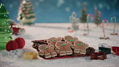 Gingerbread-Men-Sitting-On-a-Plate-in-a-Snowing-Winter-Wonderland