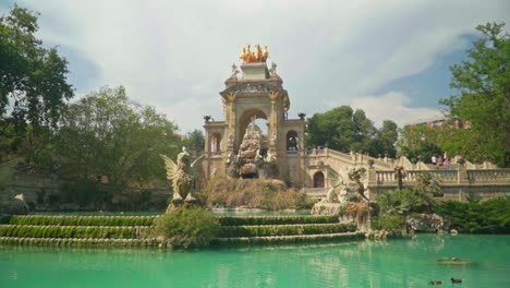 Stunning-video-of-a-girl-in-green-dress-and-knitted-hat-watching-Cascada-Monumental-in-Parc-de-la-Ciutadella,-Barcelona---Spain
