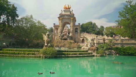 Stunning-video-of-a-girl-in-green-dress-and-knitted-hat-watching-Cascada-Monumental-in-Parc-de-la-Ciutadella,-Barcelona---Spain
