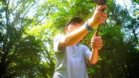Youth-swinging-a-fishing-rod-and-releasing-the-line